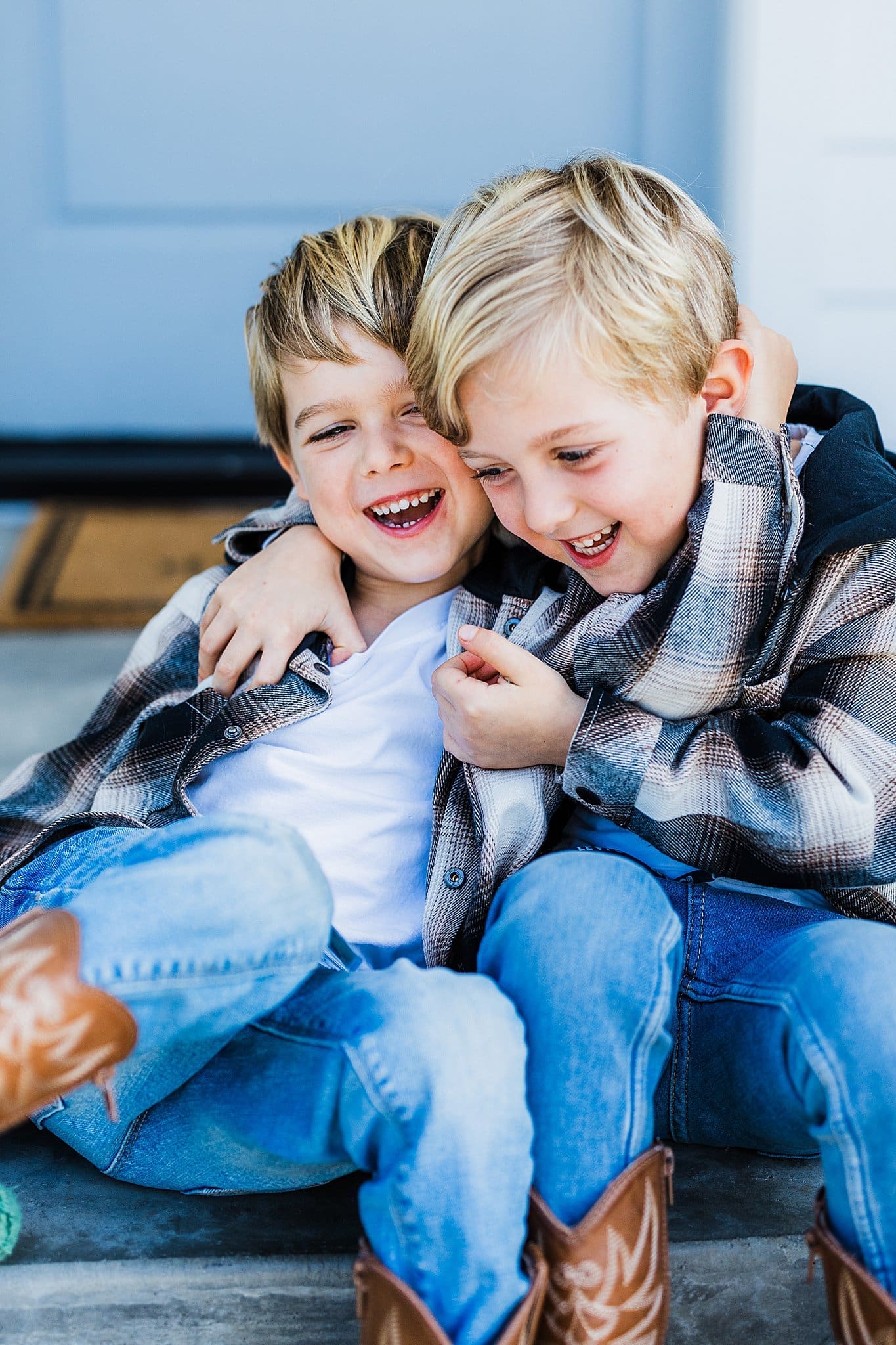 Two young brothers giggling during a family photography session